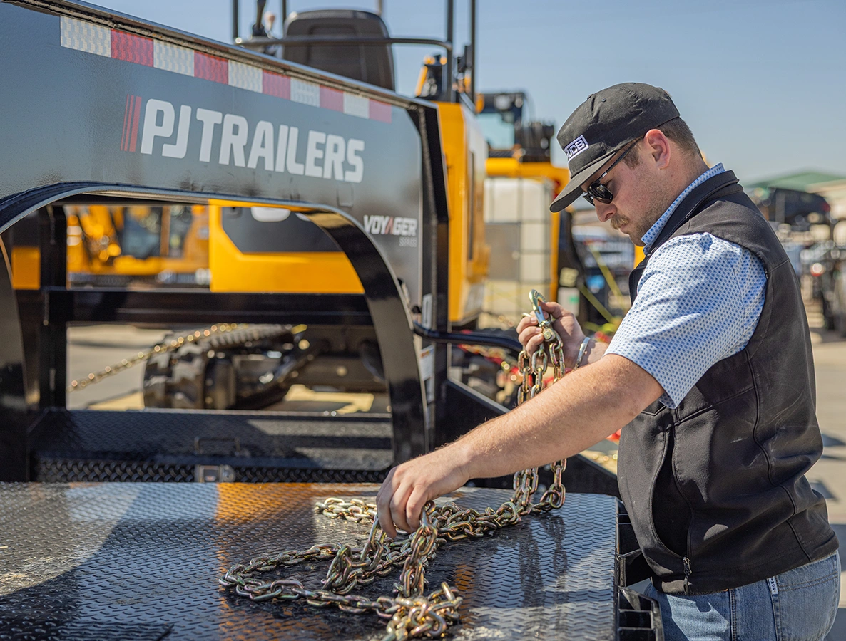 Man hooking up a PJ Trailer.